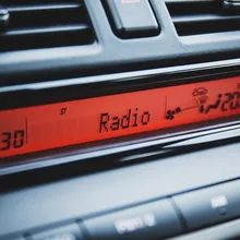 car dashboard radio and clock in blue car interior