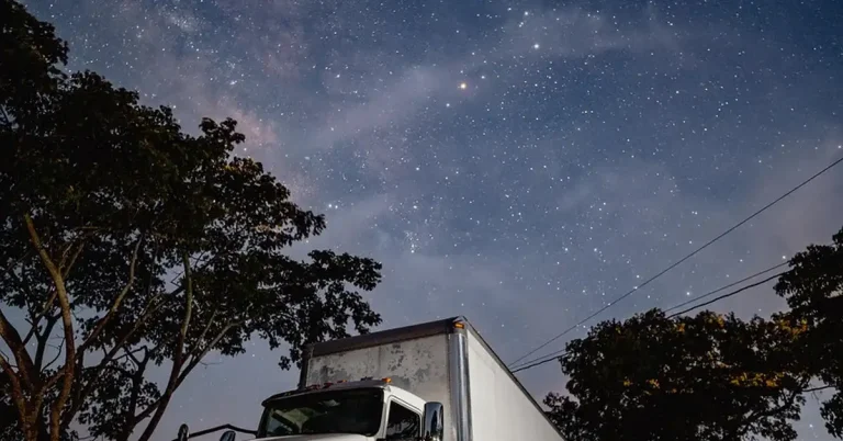 diesel truck parked idling overnight under night sky
