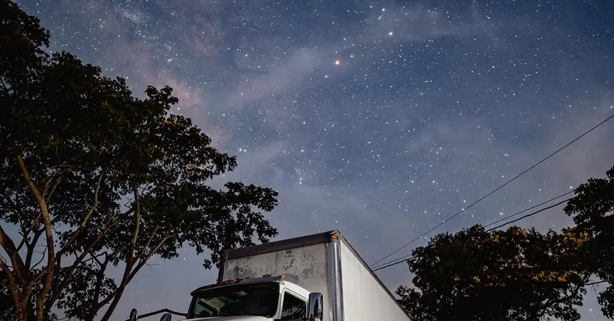 diesel truck parked idling overnight under night sky