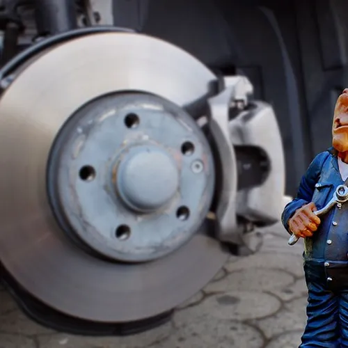 mechanic inspecting brake disc and caliper for ABS wheel bearing issue