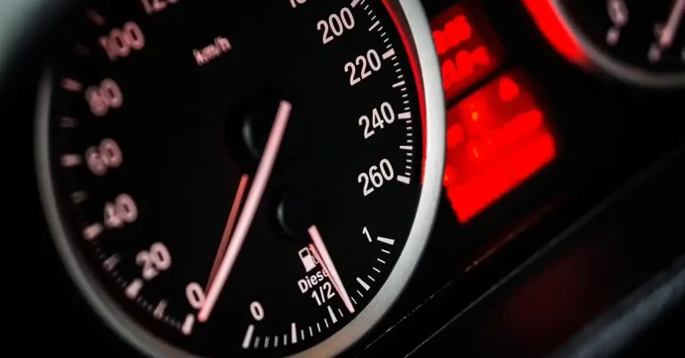 car dashboard speedometer showing warning light indicators