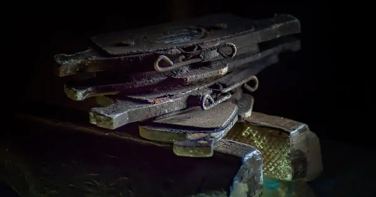 worn car brake pad and disc close-up