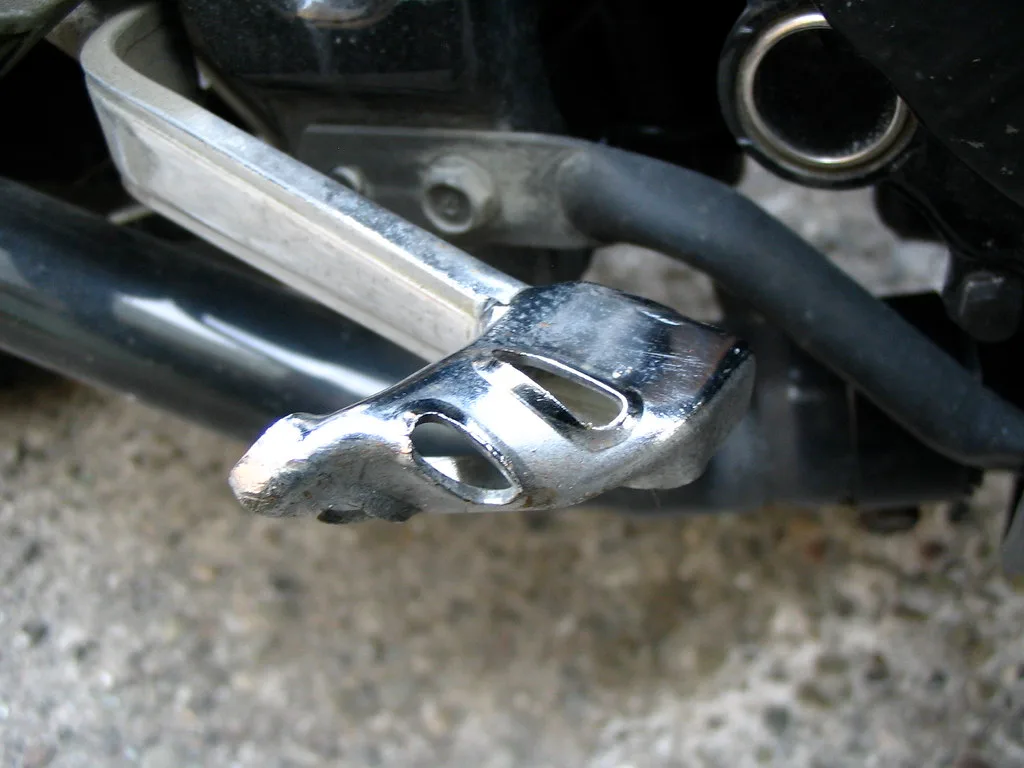 Technician hand pressing a brake pedal to check travel and return