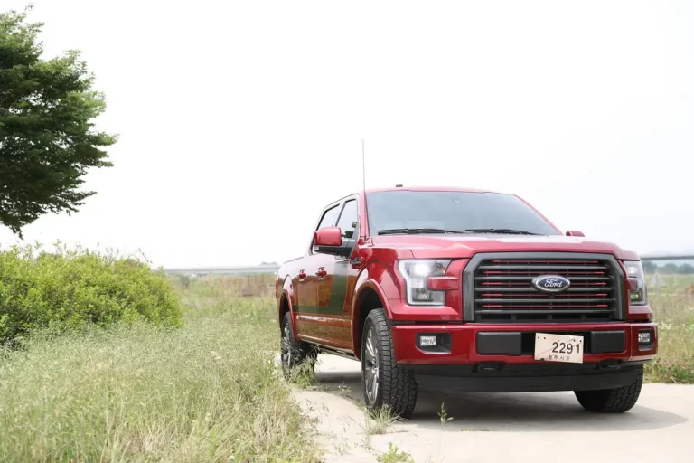 Ford F-150 and Ford Ranger parked side by side with people comparing size and space.