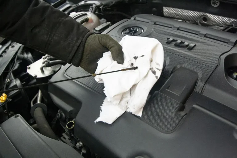Ford crossover beside service receipts and a calculator in a driveway