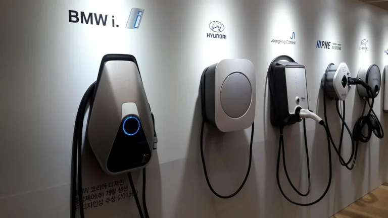 EV plugged into a home charger in a driveway at dusk