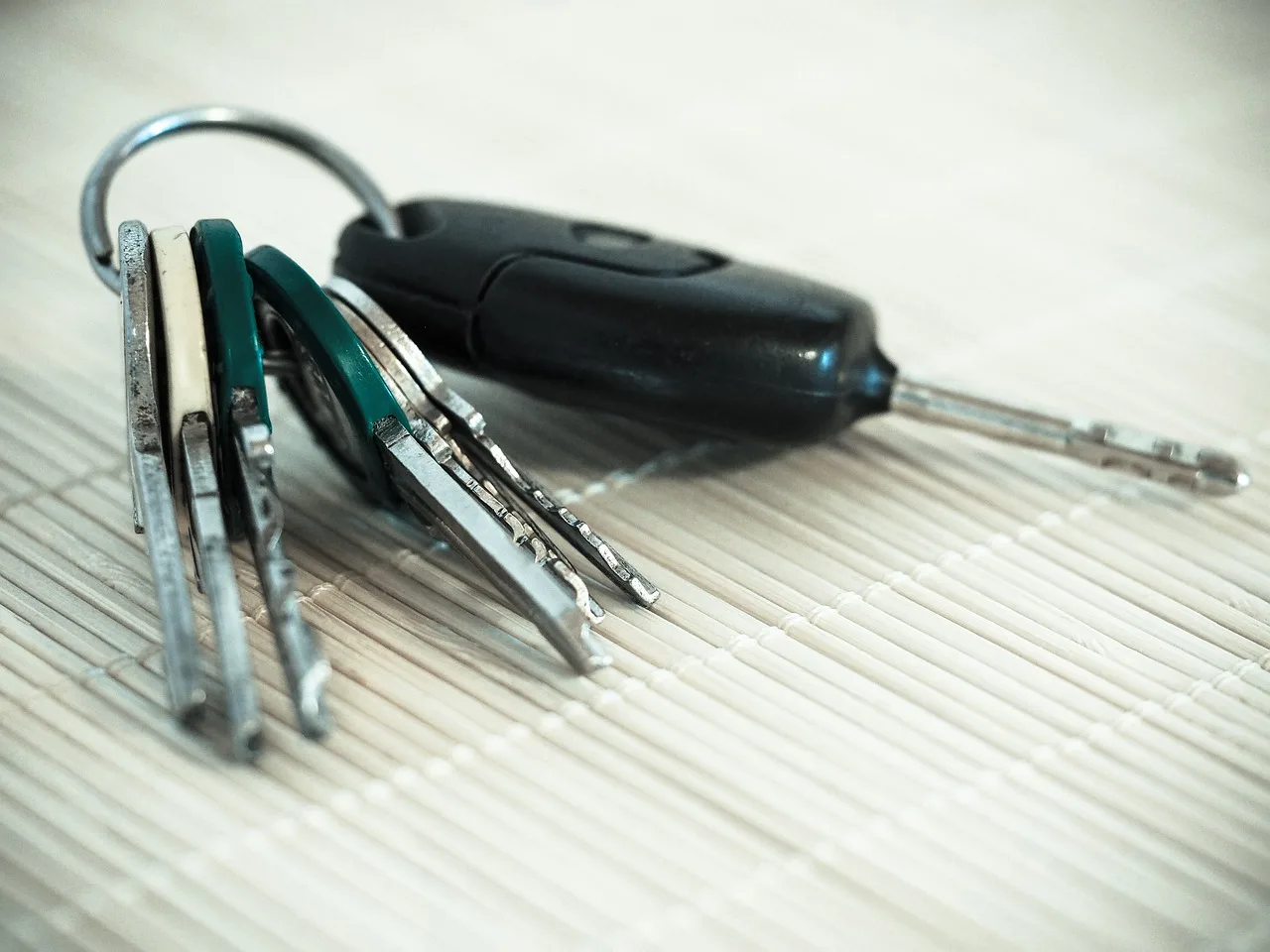A couple compares a new car and used car beside parked vehicles at a dealership