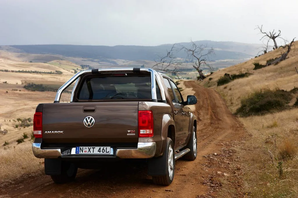 2WD vs AWD vs 4WD vehicle types shown as a city crossover, mountain SUV, and off-road pickup