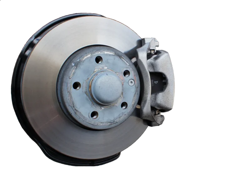 Driver beside a sedan with a wheel removed, showing brake pads and rotor in natural daylight.
