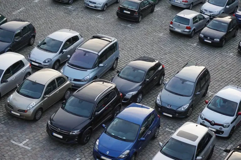 Compact hatchback parking easily on a narrow city street with other cars nearby