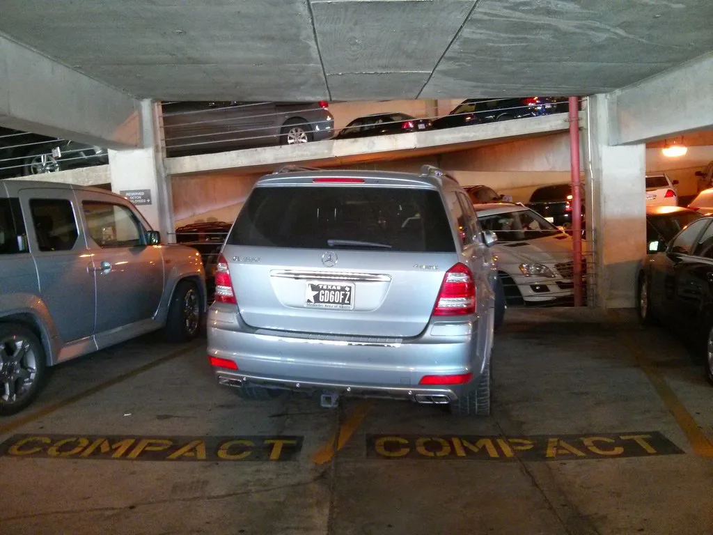 Hand plugging a charging cable into a compact SUV's charging port