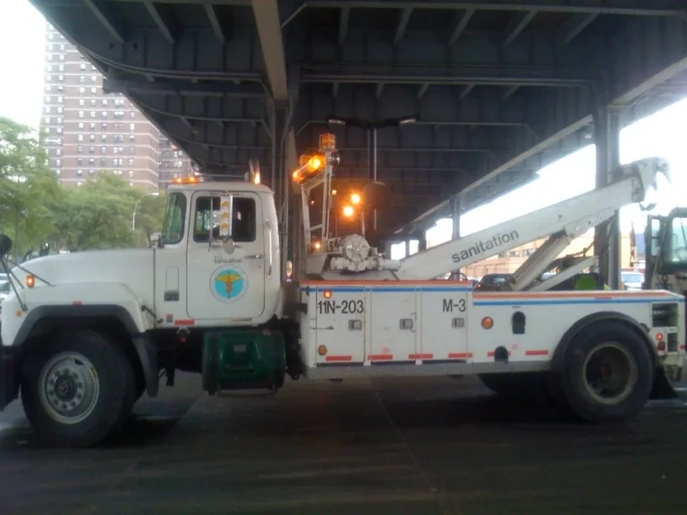 Ford F-150 towing a travel trailer on a highway with other Ford tow vehicles nearby