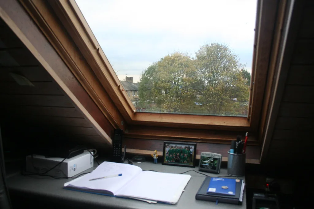 Close-up of a car reading light shining onto an open book on the center console