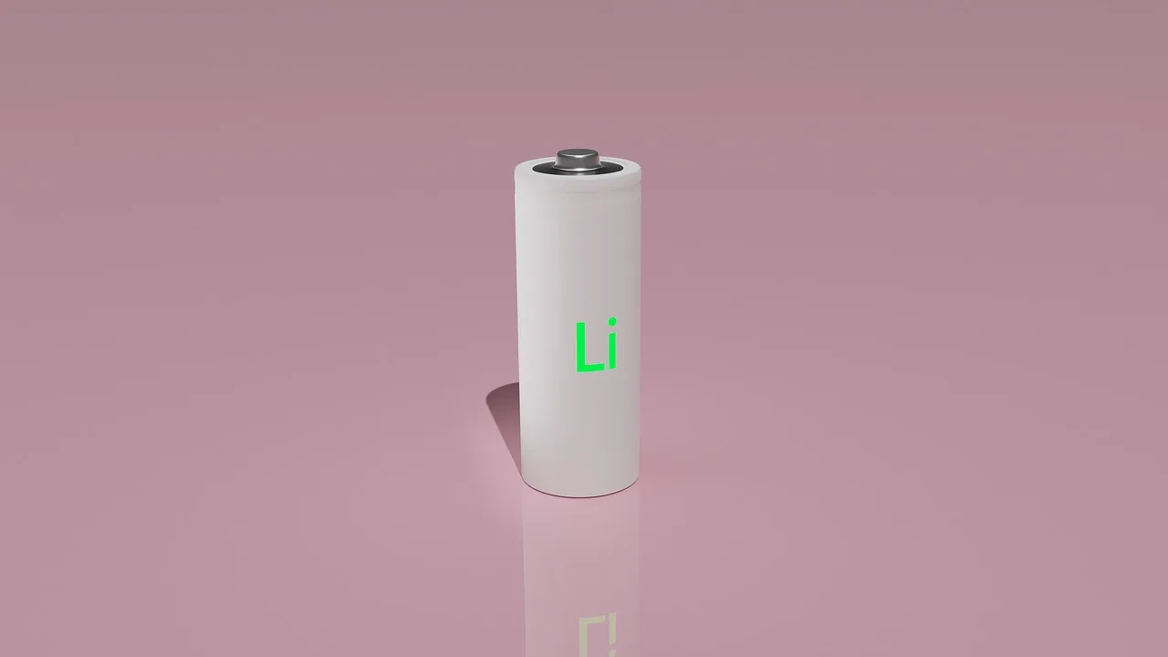 Lithium 12V car battery beside a conventional car battery under an open hood