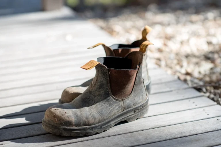 Booted foot on a textured pedal cover in a muddy winter street scene