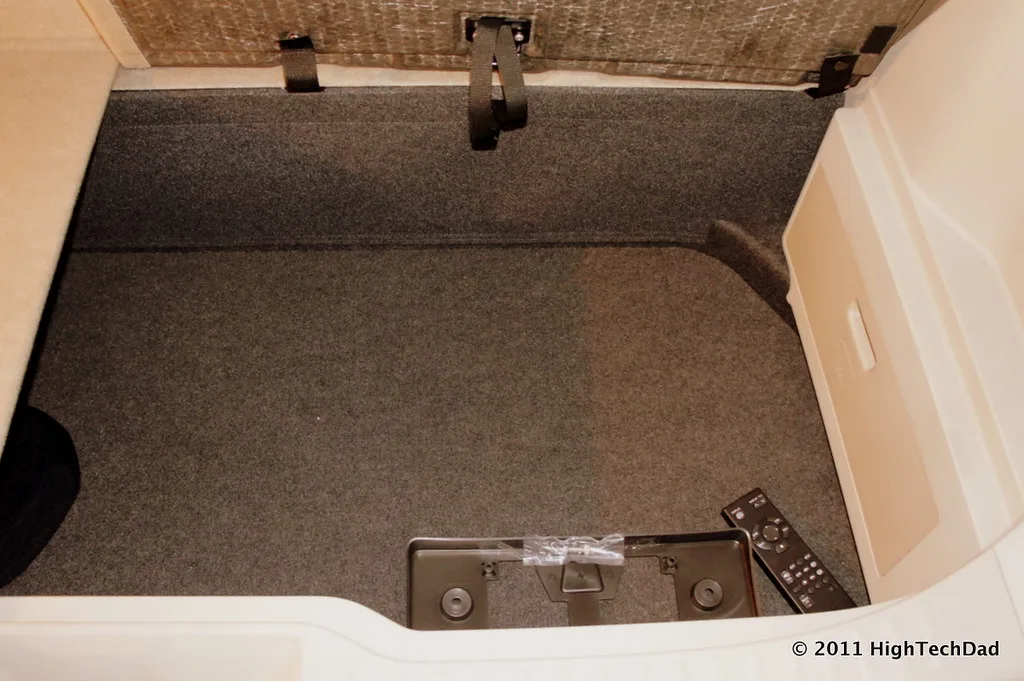 Folded stroller beside the open cargo area of a small SUV.