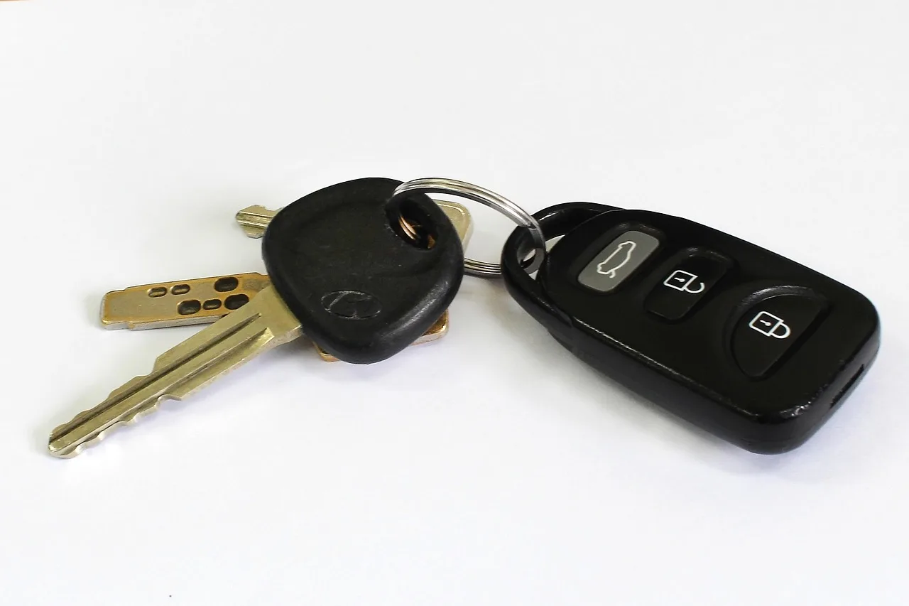 First-time car buyer compares two compact cars with a checklist on a quiet street