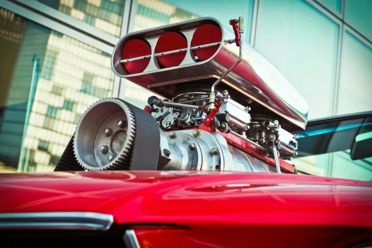 Open car engine bay with major components visible in a clean workshop under natural light
