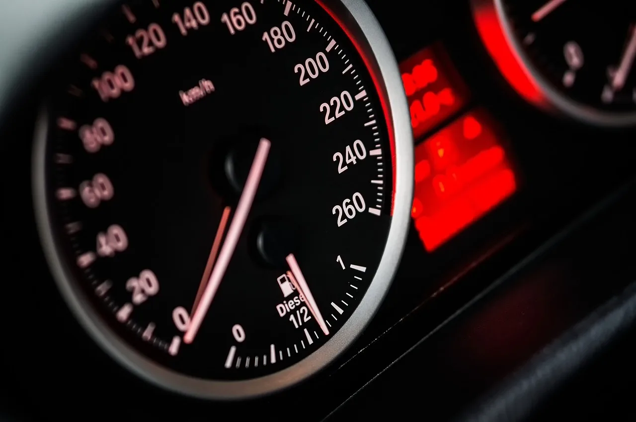 Driver viewing dashboard car light symbols glowing in the instrument cluster