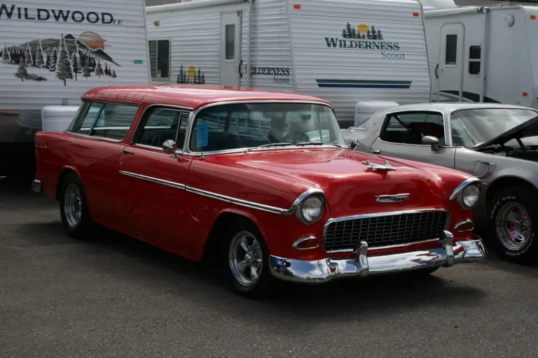 Couple comparing a coupe and a sedan in a sunlit parking lot, with the sedan’s rear door open.
