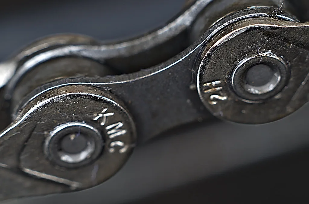 Close-up of a manual gear shifter inside a car with the pedal area blurred behind it.