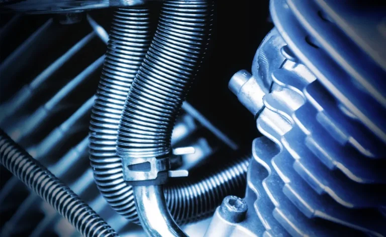 Mechanic diagnosing an engine stall at idle with a scan tool and open hood