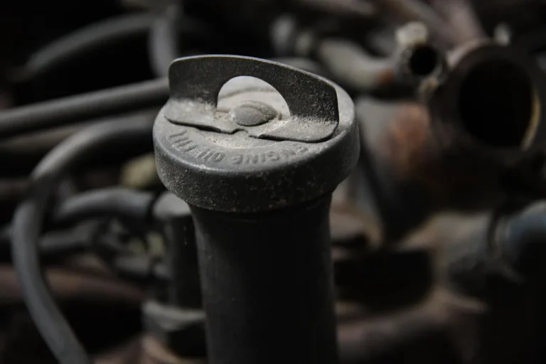 Ford vehicles parked at an auto service lot with a mechanic nearby