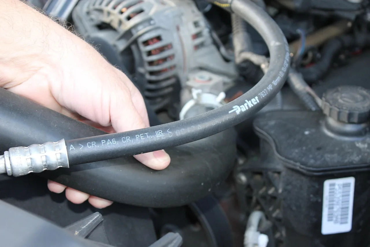Ford maintenance schedule by mileage and age shown with an owner and mechanic checking a clipboard beside a parked car