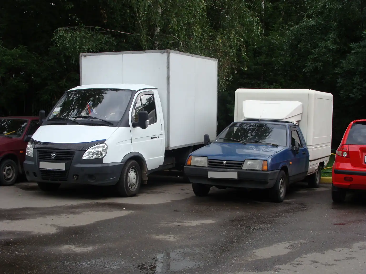 Ford Maverick hybrid and EcoBoost parked side by side in a realistic driveway scene with commuter and tow use cues