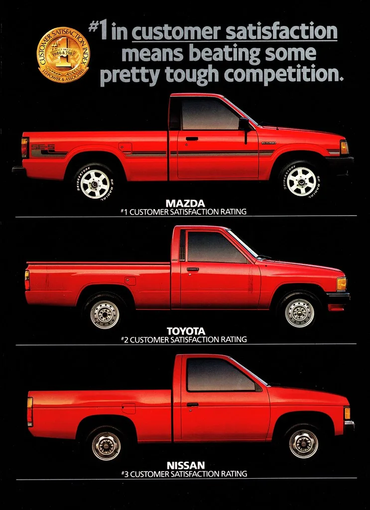 Hands compare a notebook, truck key fob, and trailer hitch ball in a realistic close-up