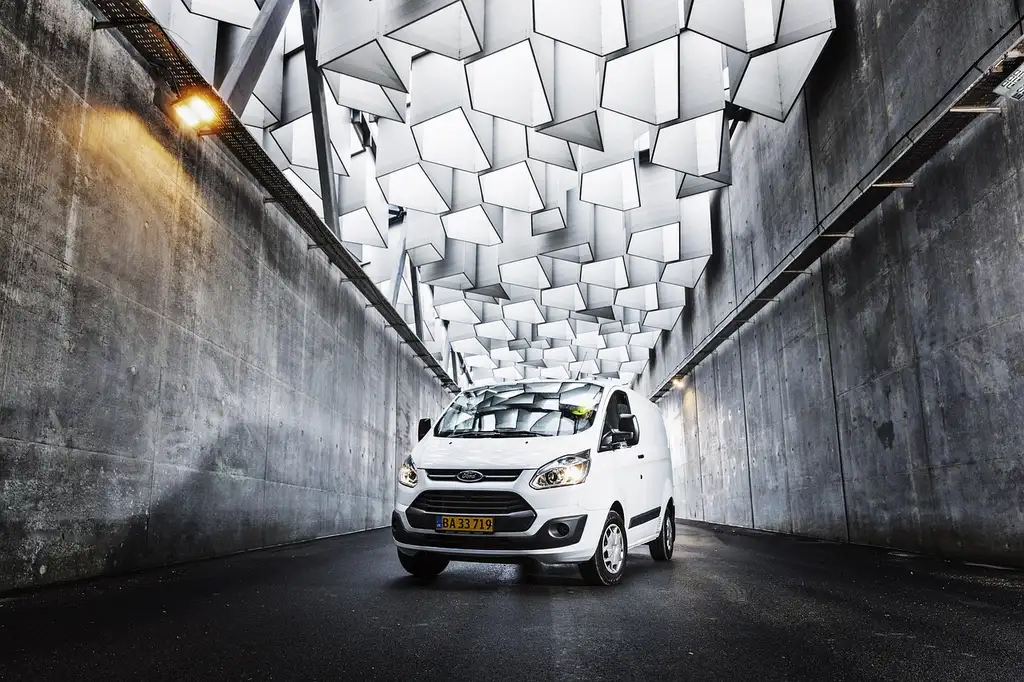 Business owner compares a Ford Transit and a Ram ProMaster parked on a city street.
