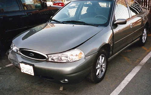 Honda Civic outside an auto shop while a mechanic and owner review a repair estimate