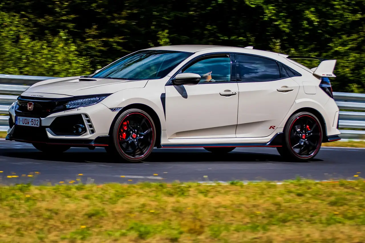 2019 Honda Civic in a driveway with a mechanic checking the engine bay