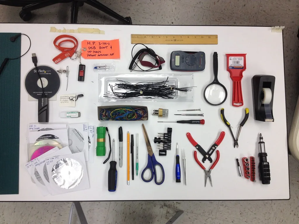 Honda Civic with hood open beside a neatly arranged maintenance kit of filters, wiper blades, fuses, and gloves