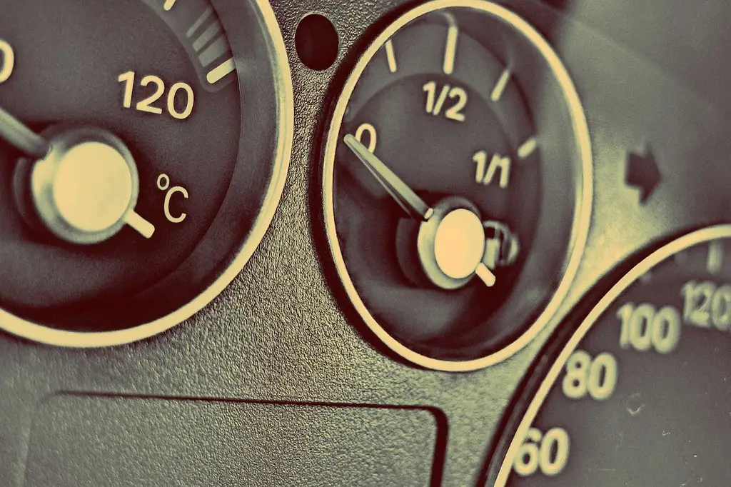 Honda Civic driver checking the dashboard maintenance light in the instrument cluster