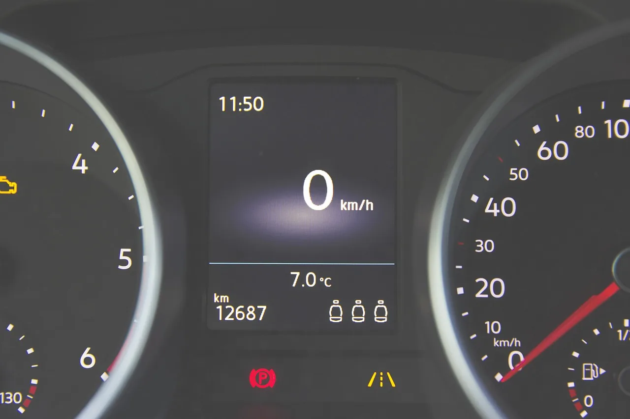 Honda Civic dashboard with a maintenance light on while the driver checks the controls