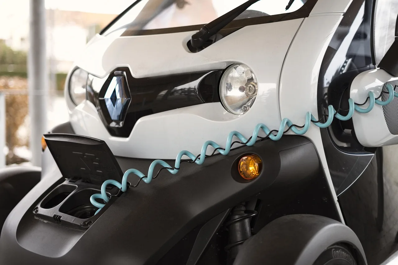 Electric car plugged into a home charger at dusk on a driveway