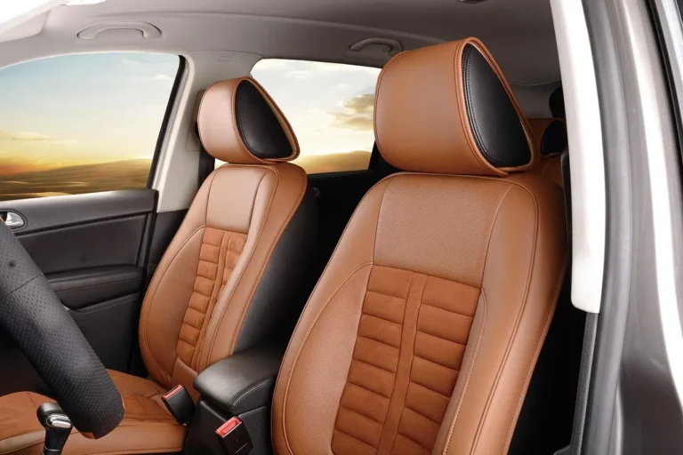 Person comparing car interior cleaner bottles beside cloth and leather car seats in natural light