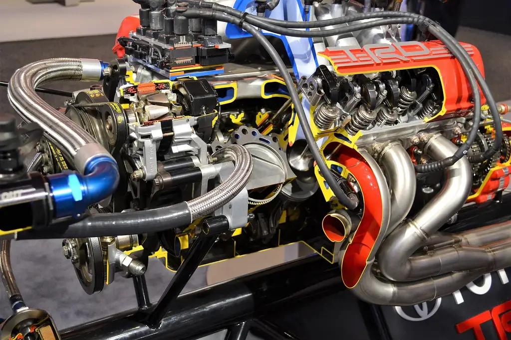 Mechanic comparing a turbocharged engine and a naturally aspirated engine in a garage