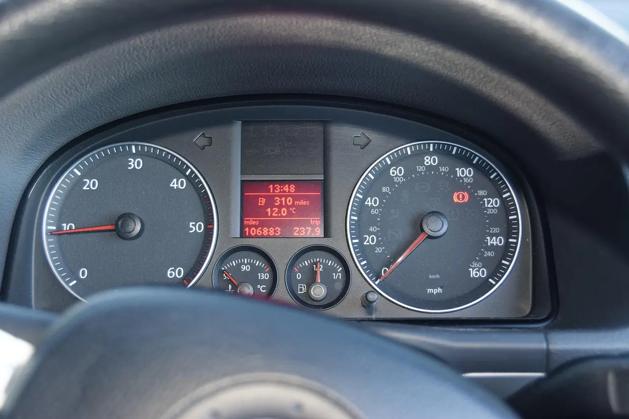 Ford owner studying a dashboard reminder inside a parked SUV in daylight