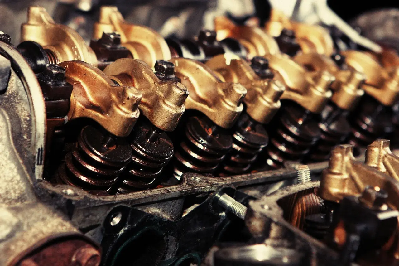 OEM and aftermarket engine parts arranged on a mechanic’s workbench in a repair garage