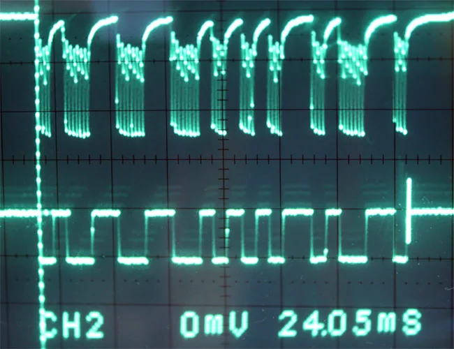 Hands testing a transmission control module connector with a multimeter