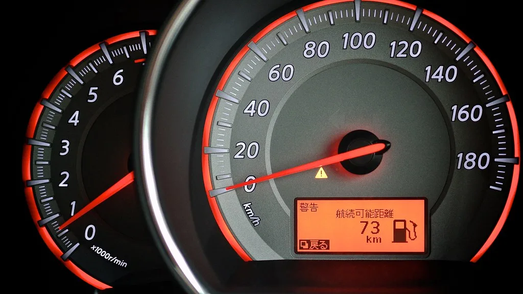 Mechanic using a diagnostic scanner at a car’s OBD-II port