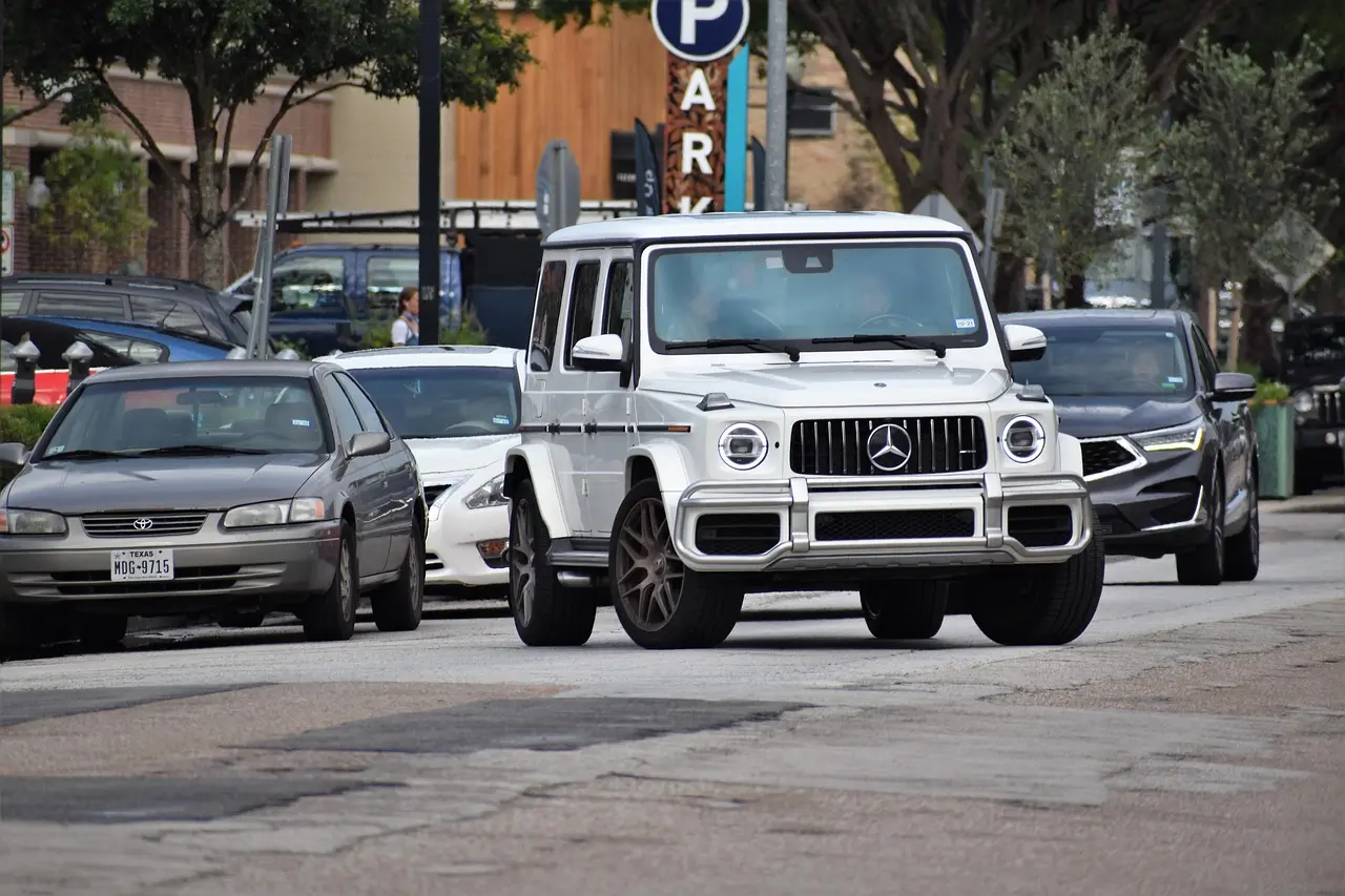 Buyer comparing a wagon and an SUV parked side by side in daylight