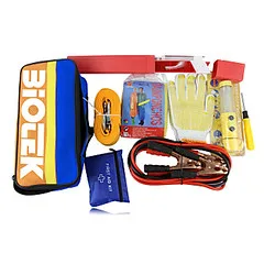 Hands pack a reflective triangle and jumper cables into a trunk organizer for a car emergency kit.