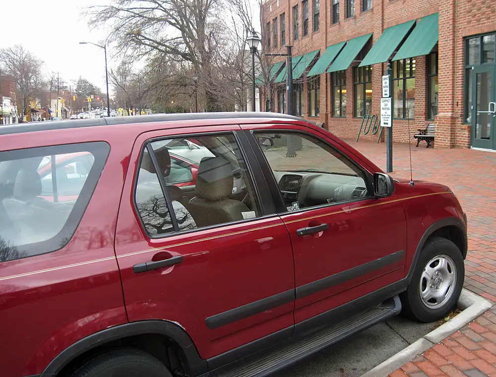 A compact car rear seat and cargo area showing flexible storage space