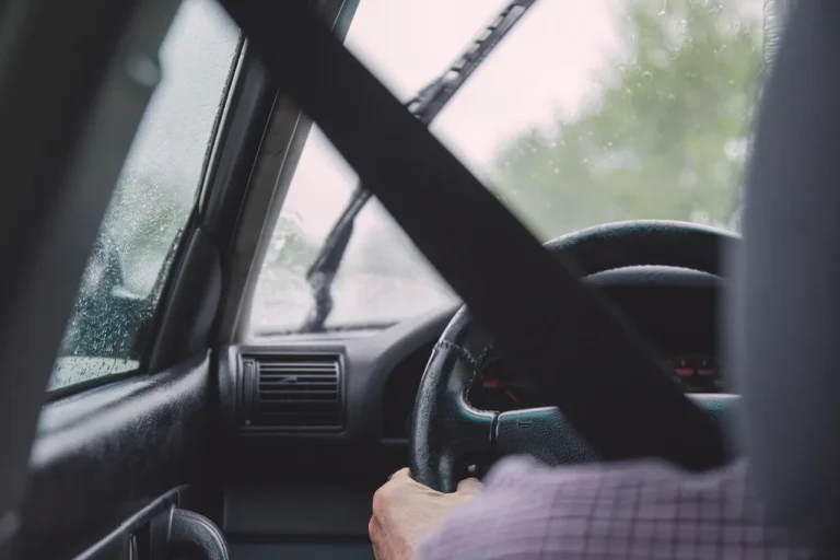 New driver in a compact crossover SUV with an instructor in the passenger seat
