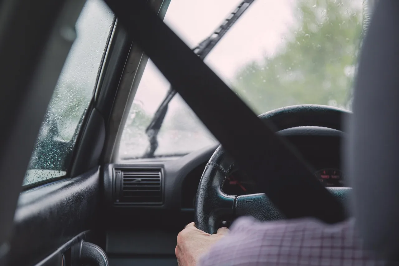 New driver in a compact crossover SUV with an instructor in the passenger seat