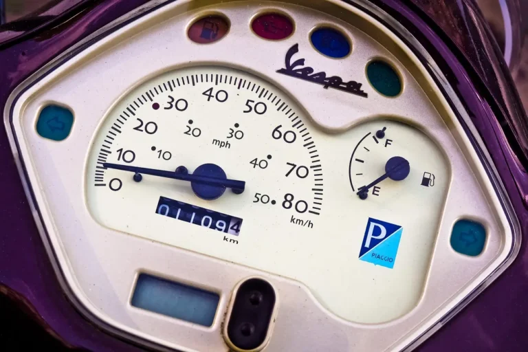 Driver beside a car with the oil pressure warning light on at dawn