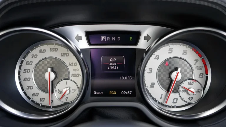 Driver looking at a car dashboard with a temperature gauge near the red zone in natural daylight